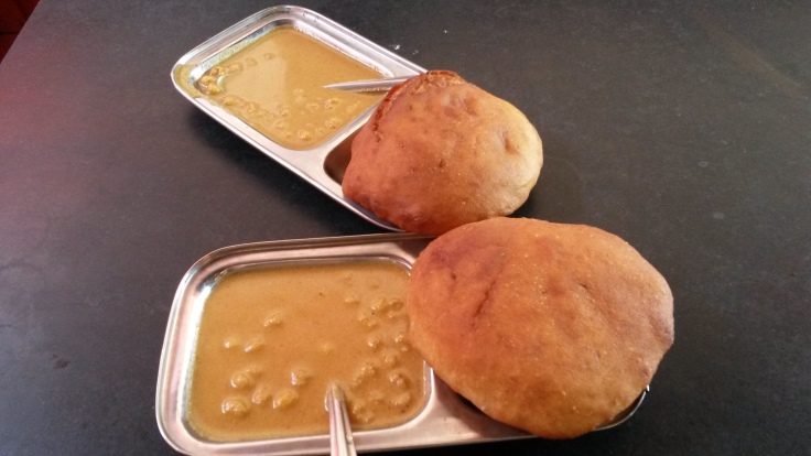 Sweet and leavened deep fried buns with a coconut gravy